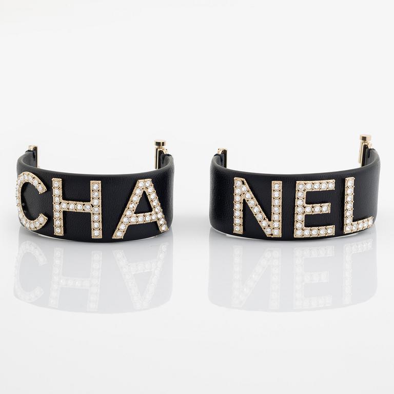 Chanel, a pair of black leather and rhinestone bracelets.