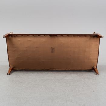 A mahogany sofa, with two armchairs and a round table, early 20th Century.