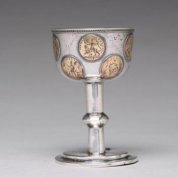 A Swedish 18th century parcel-gilt silver tumbler / cup, with copper coins, unmarked.