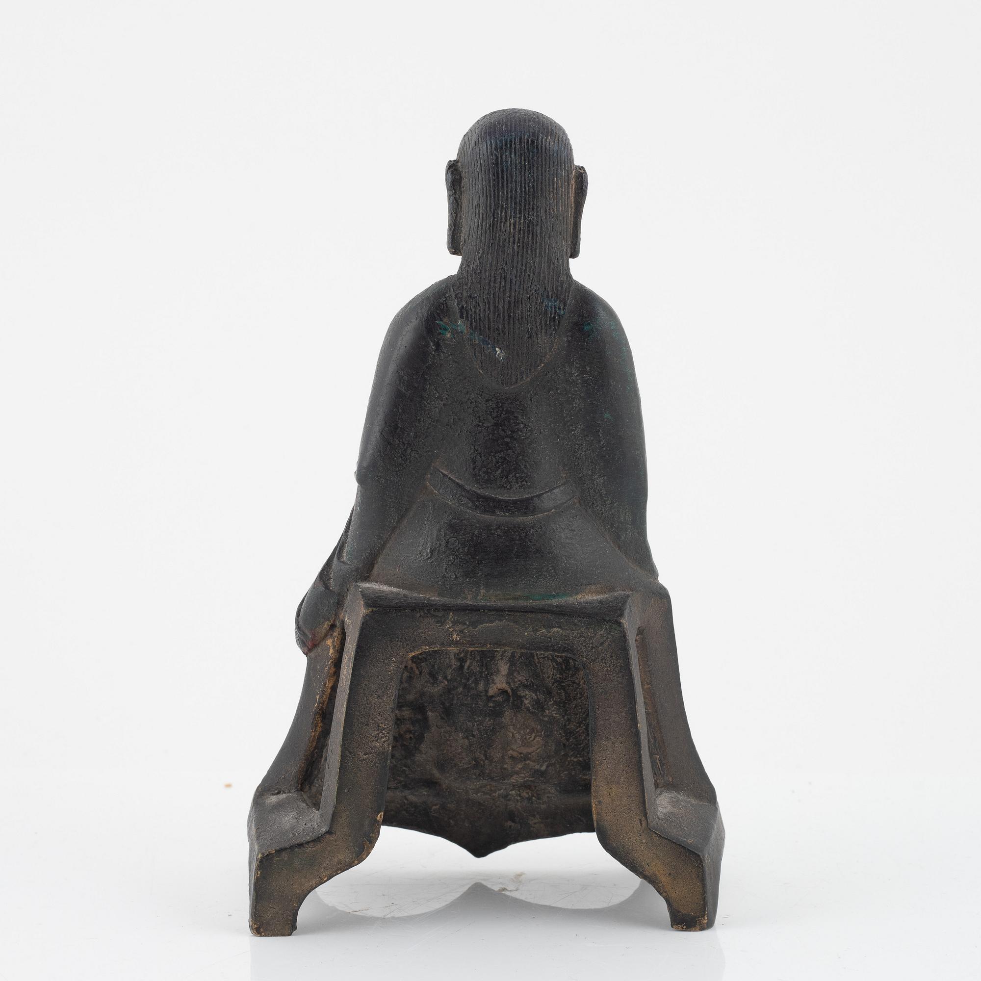 A bronze sculpture of a seated deity, Ming style, probably 20th Century.