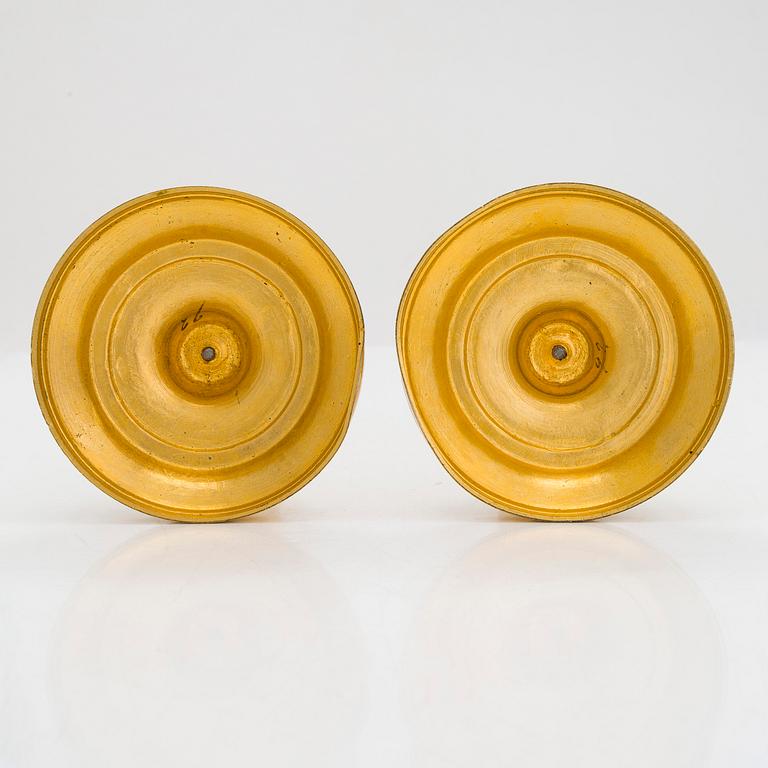 A pair of mid-19th-century gilded bronze candlesticks.