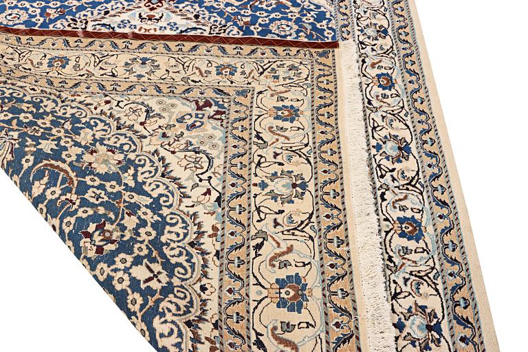 A Nain carpet, part silk, 9 laa, c. 300 x 189 cm.