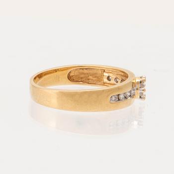 An 18K gold ring set with round brilliant-cut diamonds.