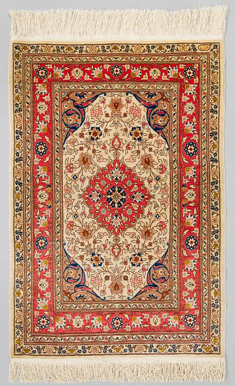 A Kashmir silk carpet. Circa 102 x 69 cm.