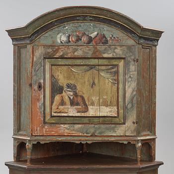 A Swedish polychrome-painted corner cabinet attributed to J. Bäckström (1773-1837).