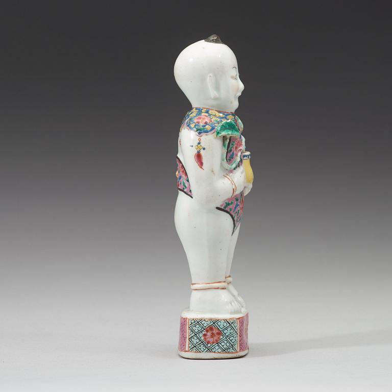 A famille rose figure of a boy, Qing dynasty, 18th Century.