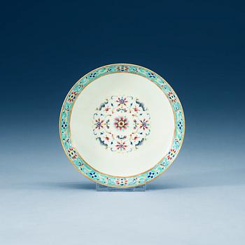 A turkoise ground famille rose dish, Qing dynasty, with Qianlongs seal mark.