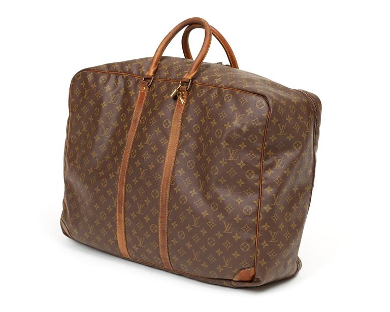 A monogram canvas softsided suitcase by Louis Vuitton.