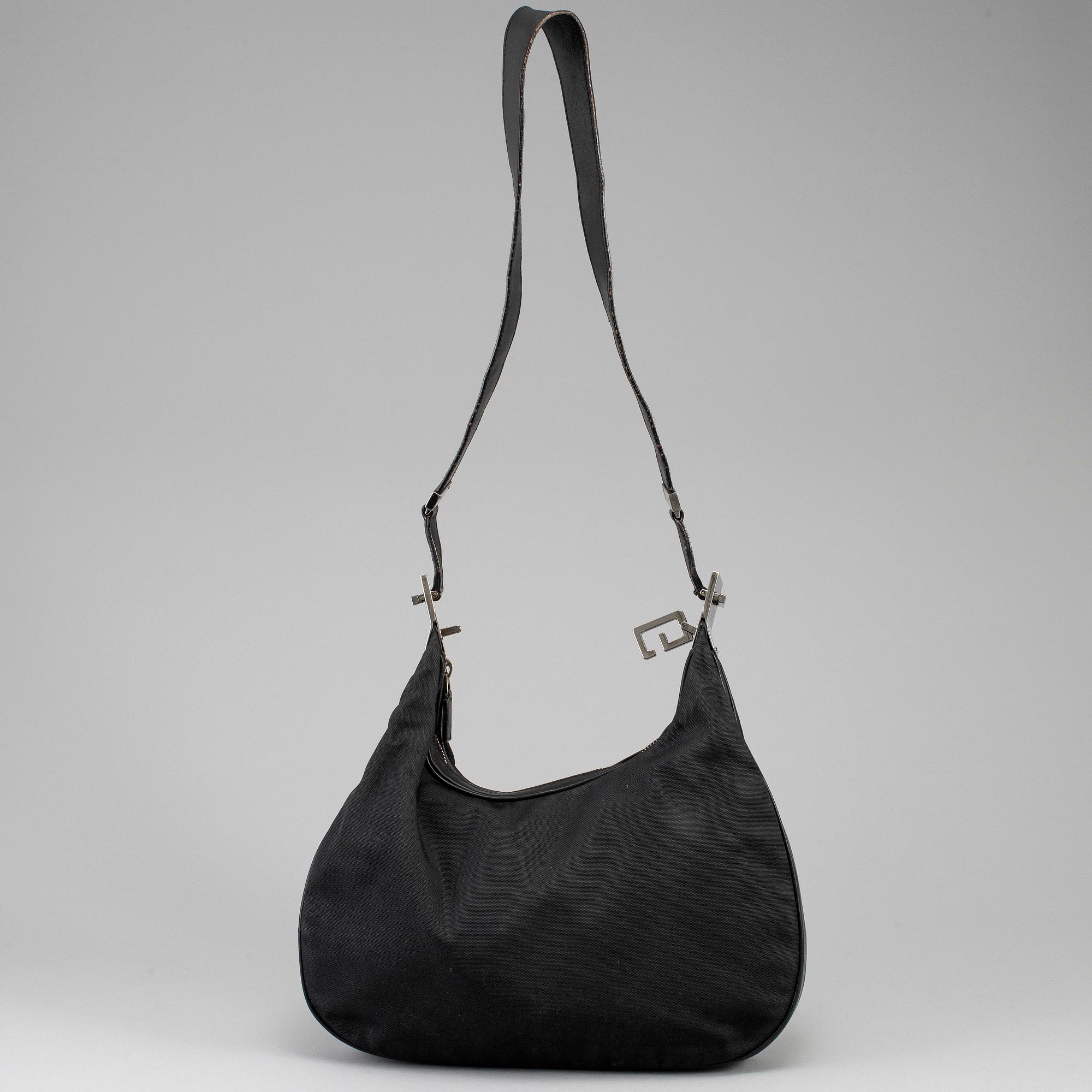 GUCCI, a canvas handbag.