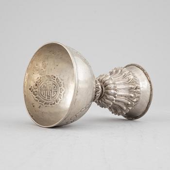 A Tibetan butter lamp, silvered copper, 20th century.