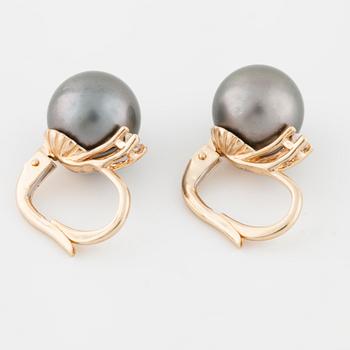 A pair of cultured Tahiti pearl and brilliant cut diamond earrings.