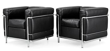 130. A pair of Le Corbusier 'LC 2' black leather and chromed steel easy chairs, by Cassina, Italy.
