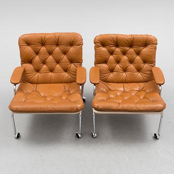 A pair of leather upholstered easy chairs, 1960's/70's.