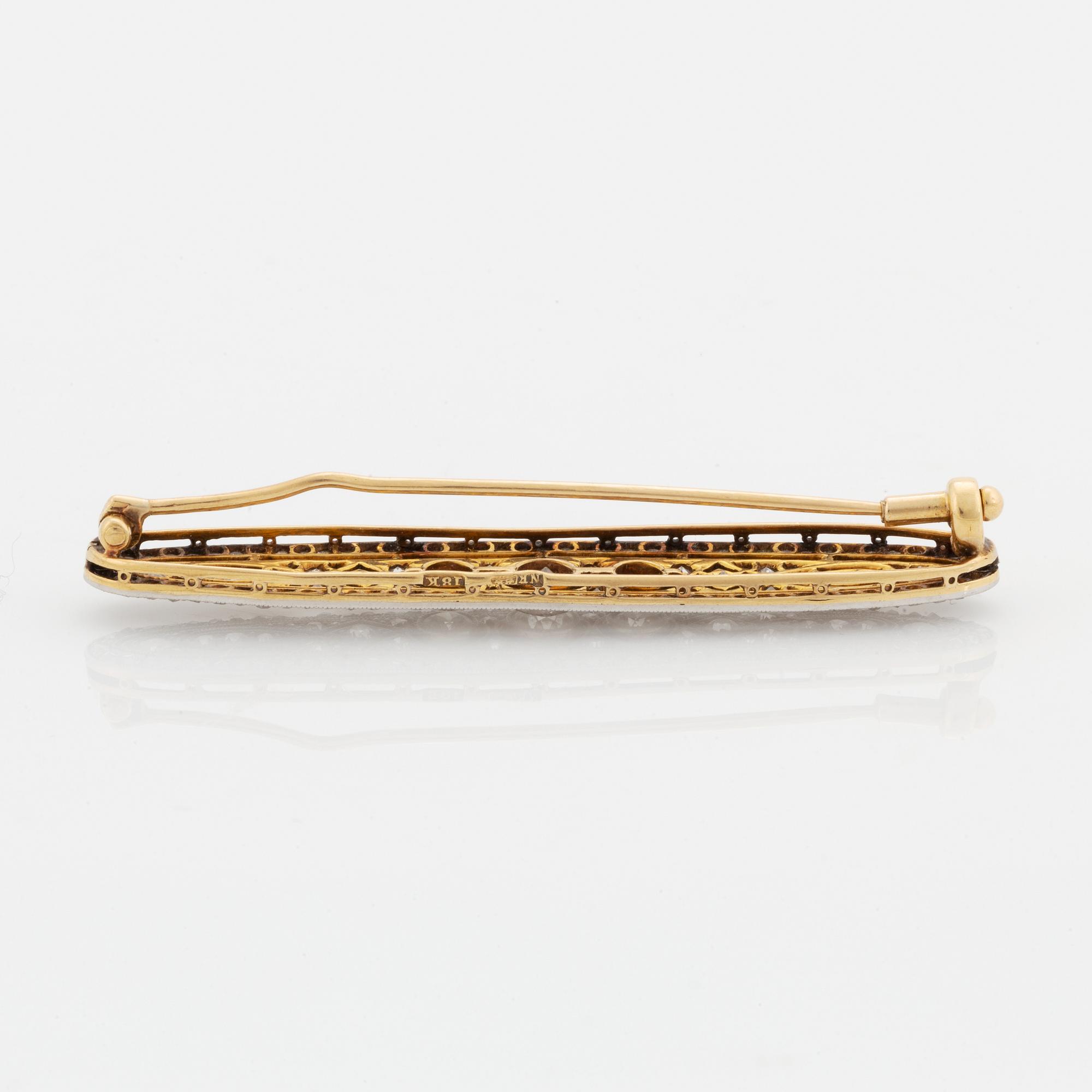 A platinum and 18K gold brooch set with old- and rose-cut diamonds.