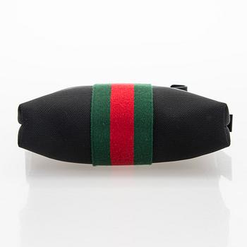 Gucci, a "Techno Canvas Web Messenger" bag.