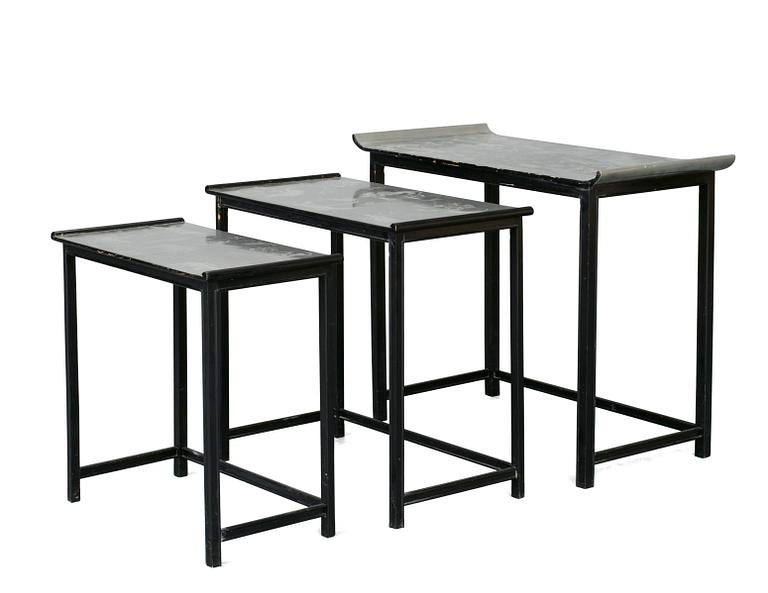 A Nils Fougstedt and Björn Trägårdh set of occasional tables in pewter and black lacquered wood for Svenskt Tenn, circa 1930, the tops with engraved scenes of figures and animals.