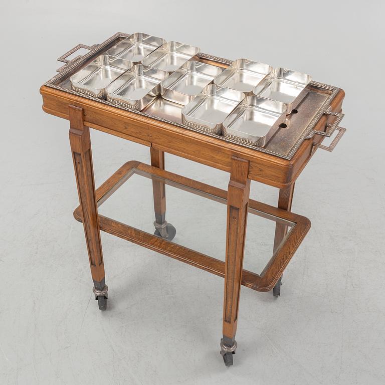 A restaurant serving trolley with silver plate dishes, first half of the/mid 20th century.
