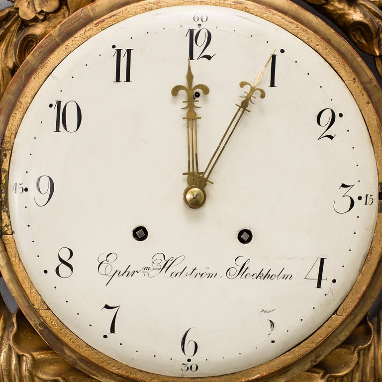 A late Gustavian gilt wood wall clock by Ephraim Hedström (active 1808-1818), Stockholm.