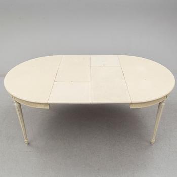 A set of eight chairs and a dining table. Gustavian style, second half of the 20th century. 2 leaves included.