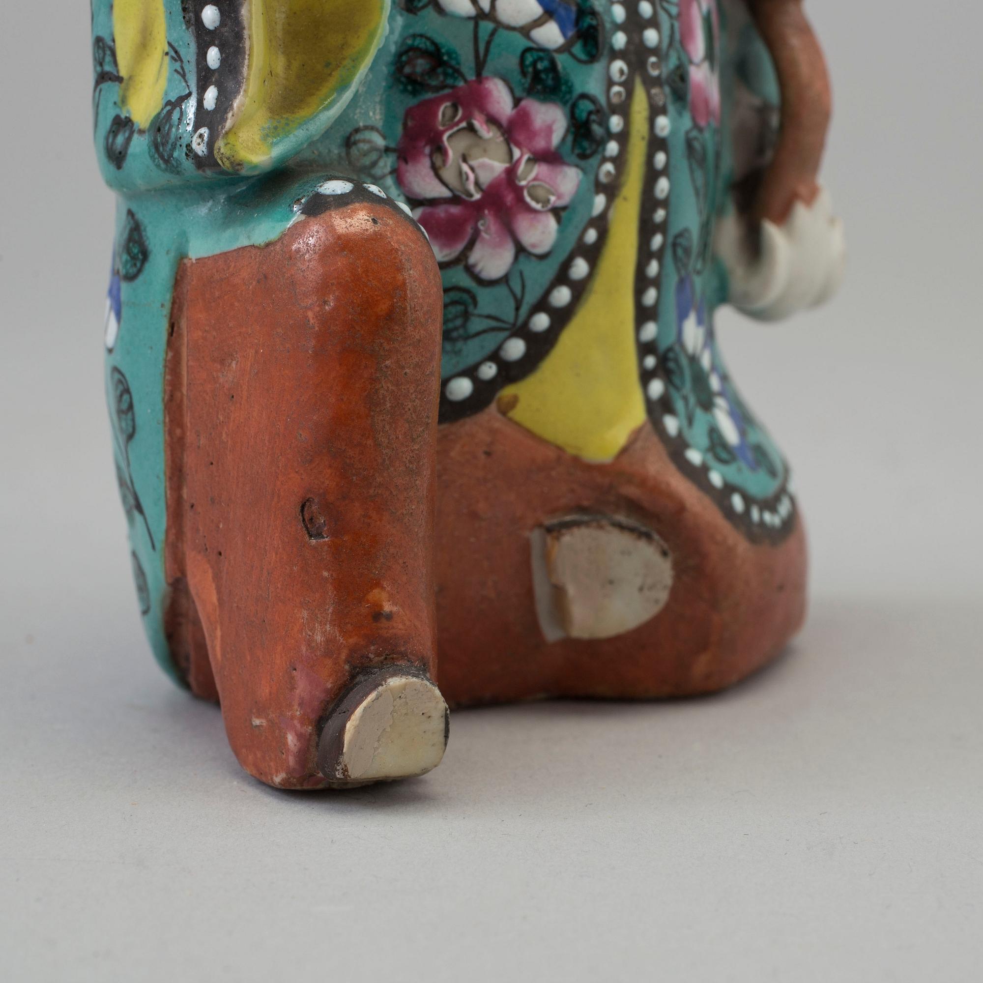 A porcelain figure of a laughing boy, Qing dynasty, 19th Century.