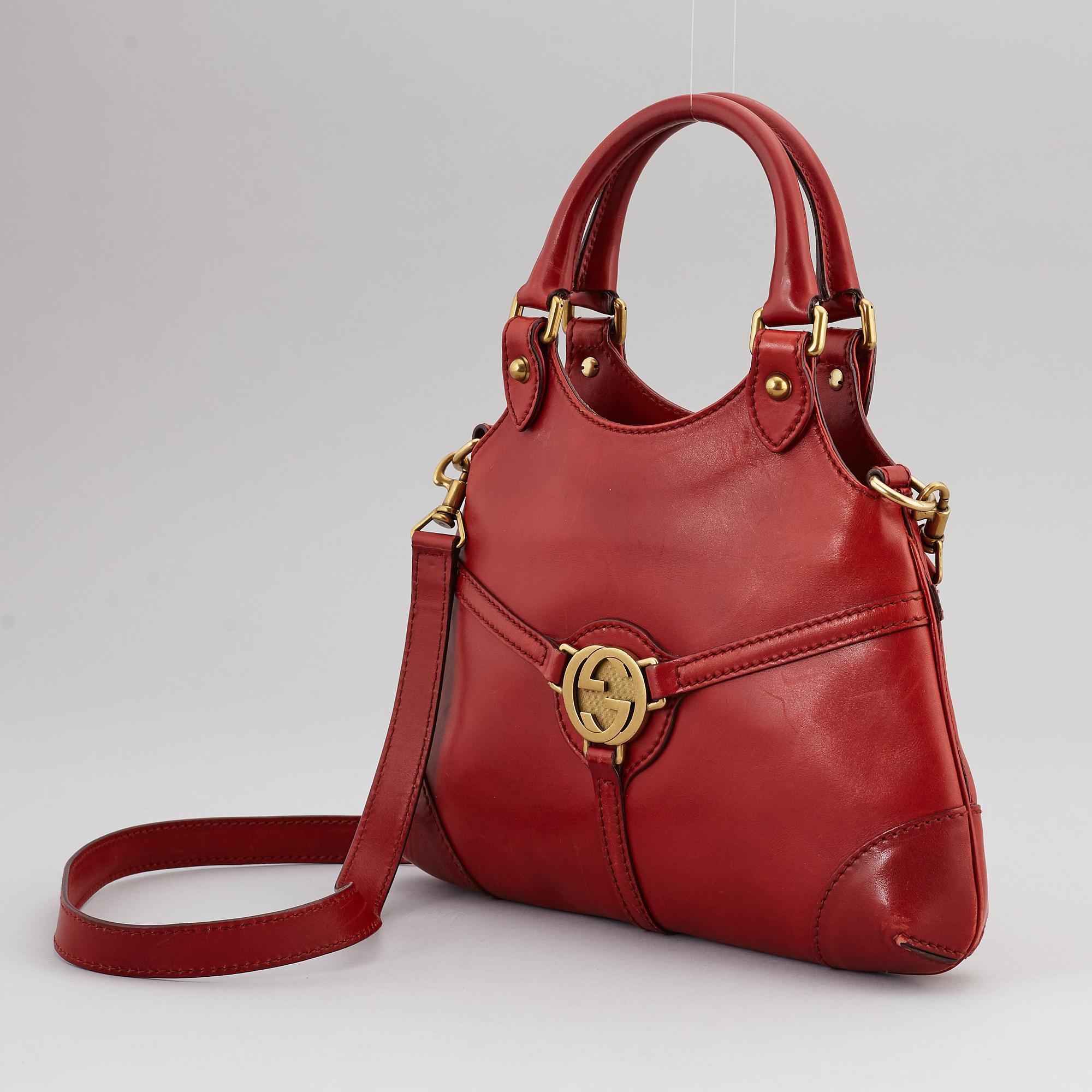 GUCCI, a red leather crossbody bag.