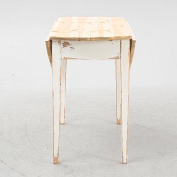 A drop-leaf table, circa 1900.