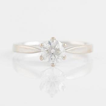 A 14K gold ring set with a round brilliant-cut diamond.