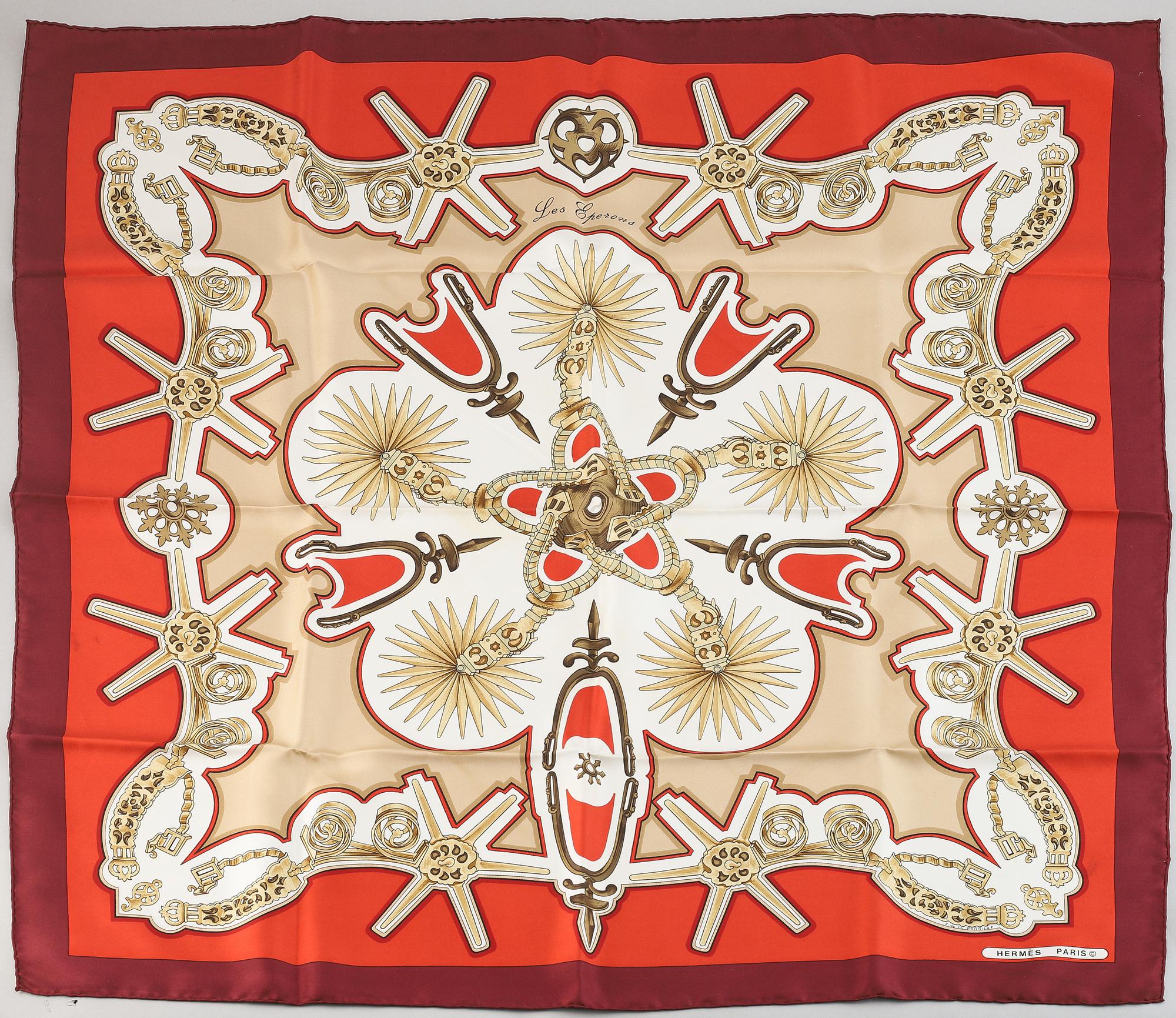Hermès, a 'Les Eperons' silk scarf.