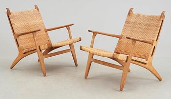 A pair of Hans J Wegner oak and rattan 'CH-27' armchairs, Carl Hansen & Son, Denmark, 1950's-60's.