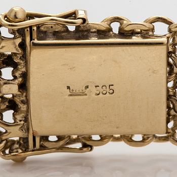 A 14K gold X-link bracelet, likely Norway.