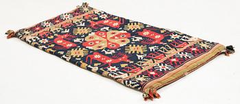 A double-interlocked tapestry carrige cushion from Scania, ca 99 x 49 cm, first half of the 19th century.