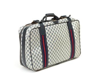 A travelling bag by Gucci.