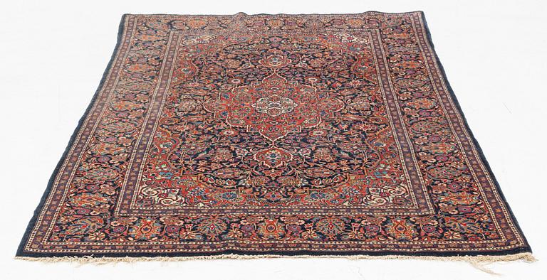 A semi-antique Kashan rug, 203 x 129 cm.
