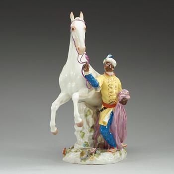 A large Meissen figure of a white horse and his groom, 20th Century.