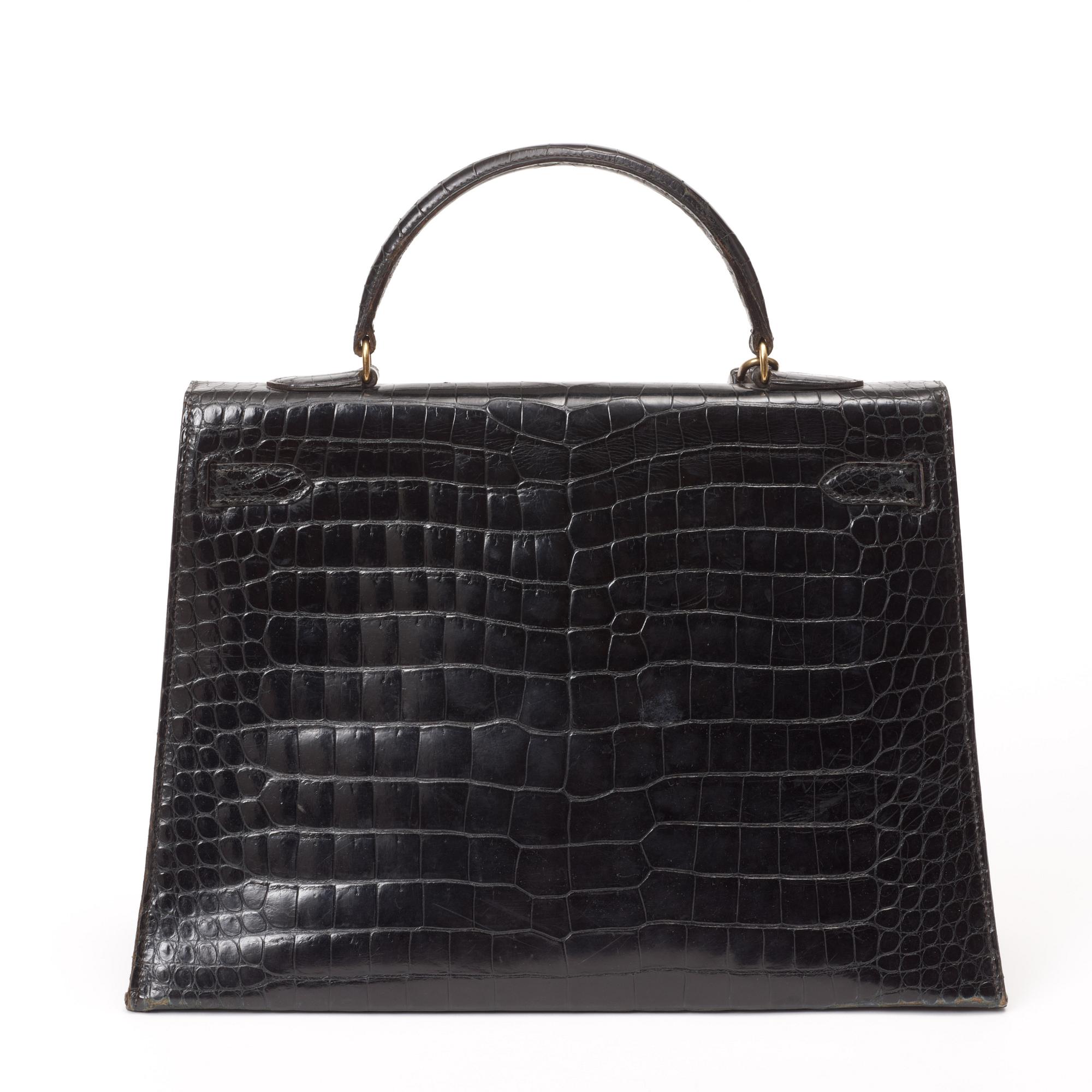 A 1960s/70s black crocodile leather handbag "Kelly" by Hermès.
