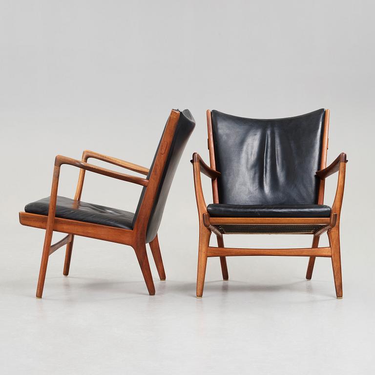 Hans J. Wegner, a pair of "AP16" teak and black leather armchairs, AP-stolen, Denmark 1950-60´s.