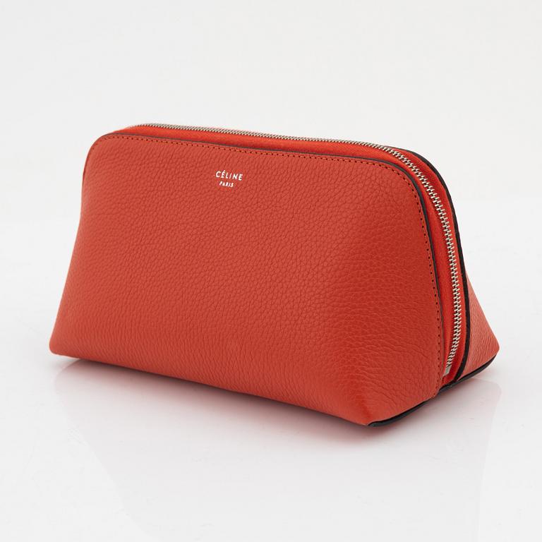 Céline, A cosmetic pouch in bright red leather.