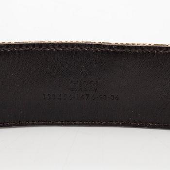 A Gucci monogram canvas leather belt.