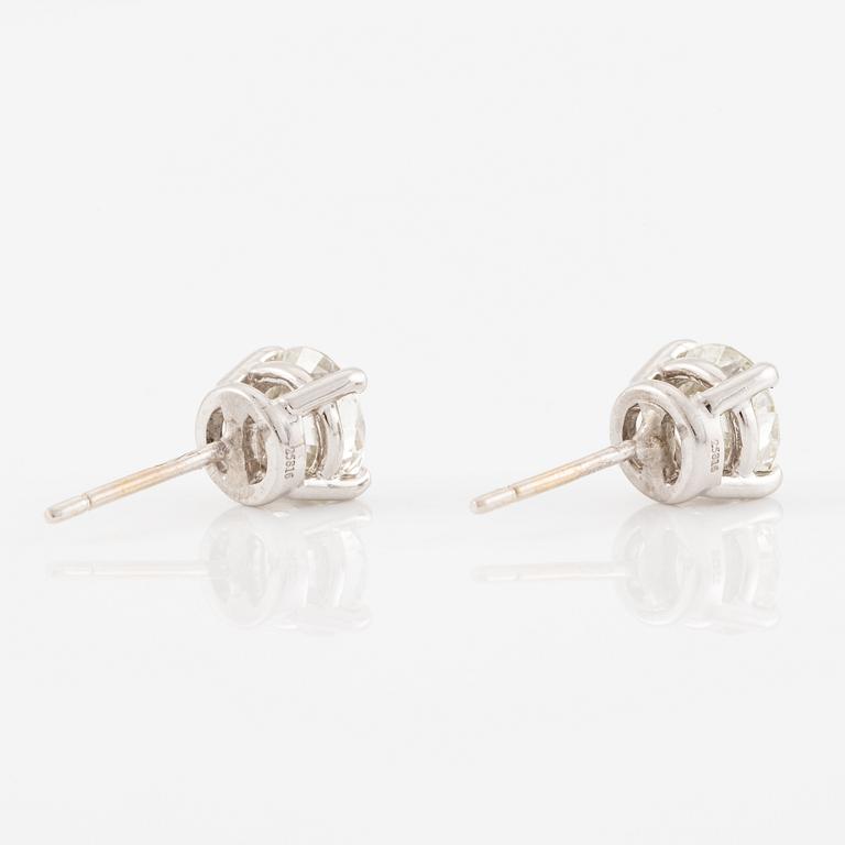 A pair of earrings in 18K white gold set with two round brilliant-cut diamonds, likely Tiffany & Co.