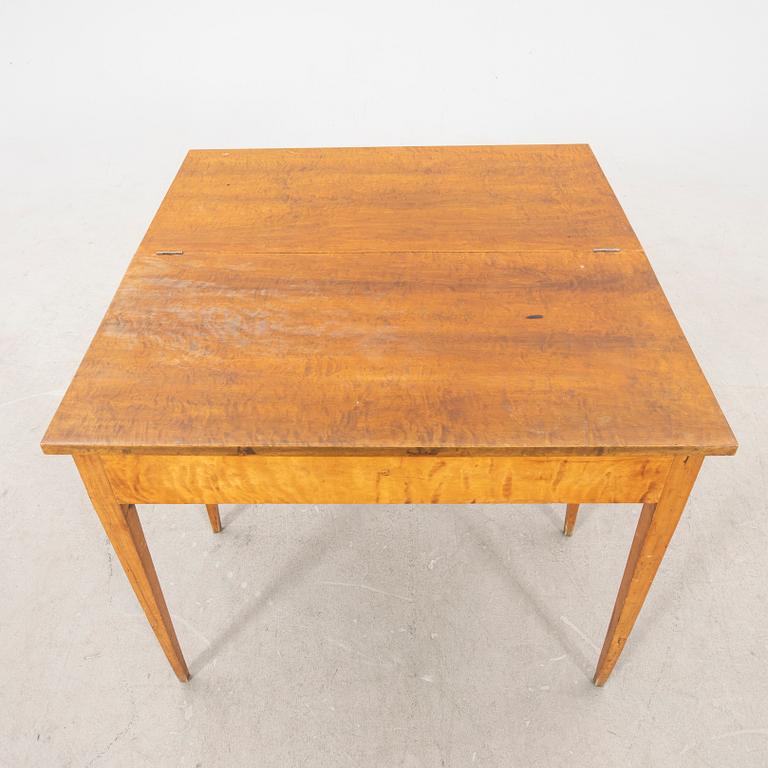 An earluy 1900s birch game table.