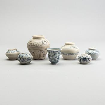 A group of six blue and white South East Asian jars and a cup, 17th/18th Century.