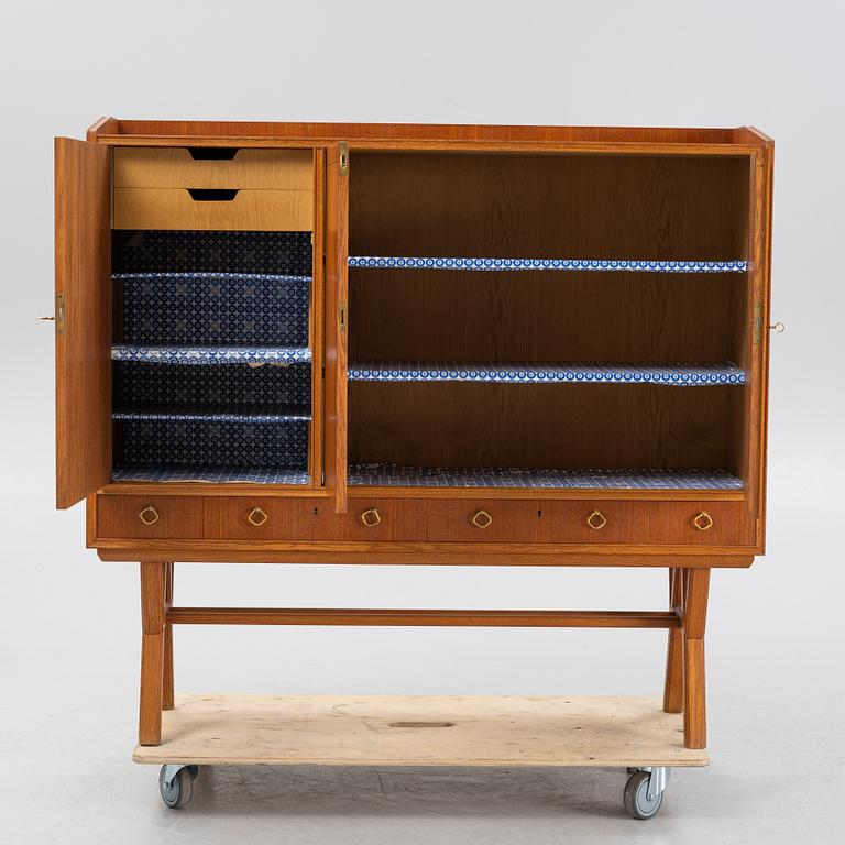 A teak-veneered mid 20th century sideboard.