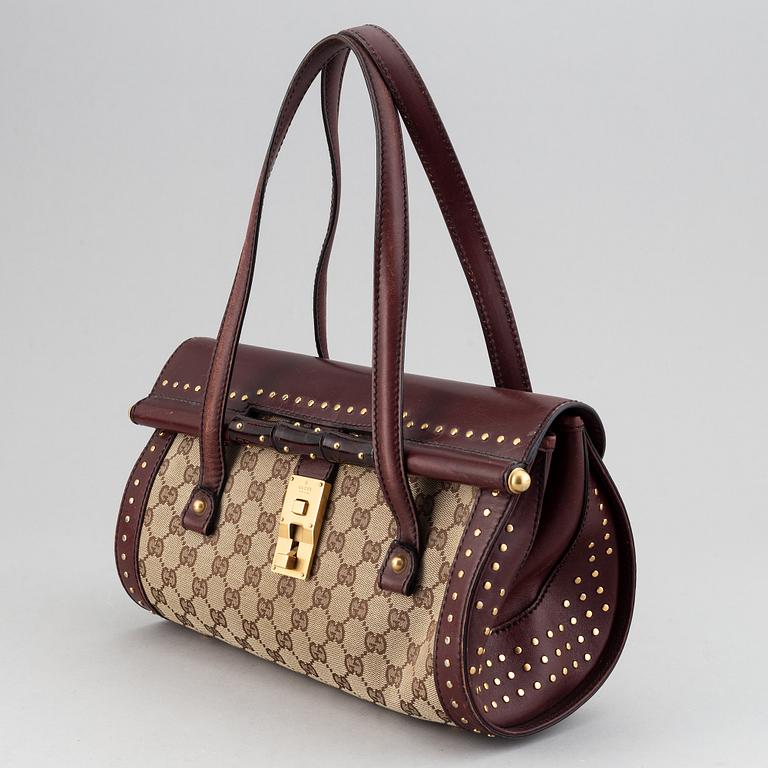 Gucci, a monogram canvas bag.