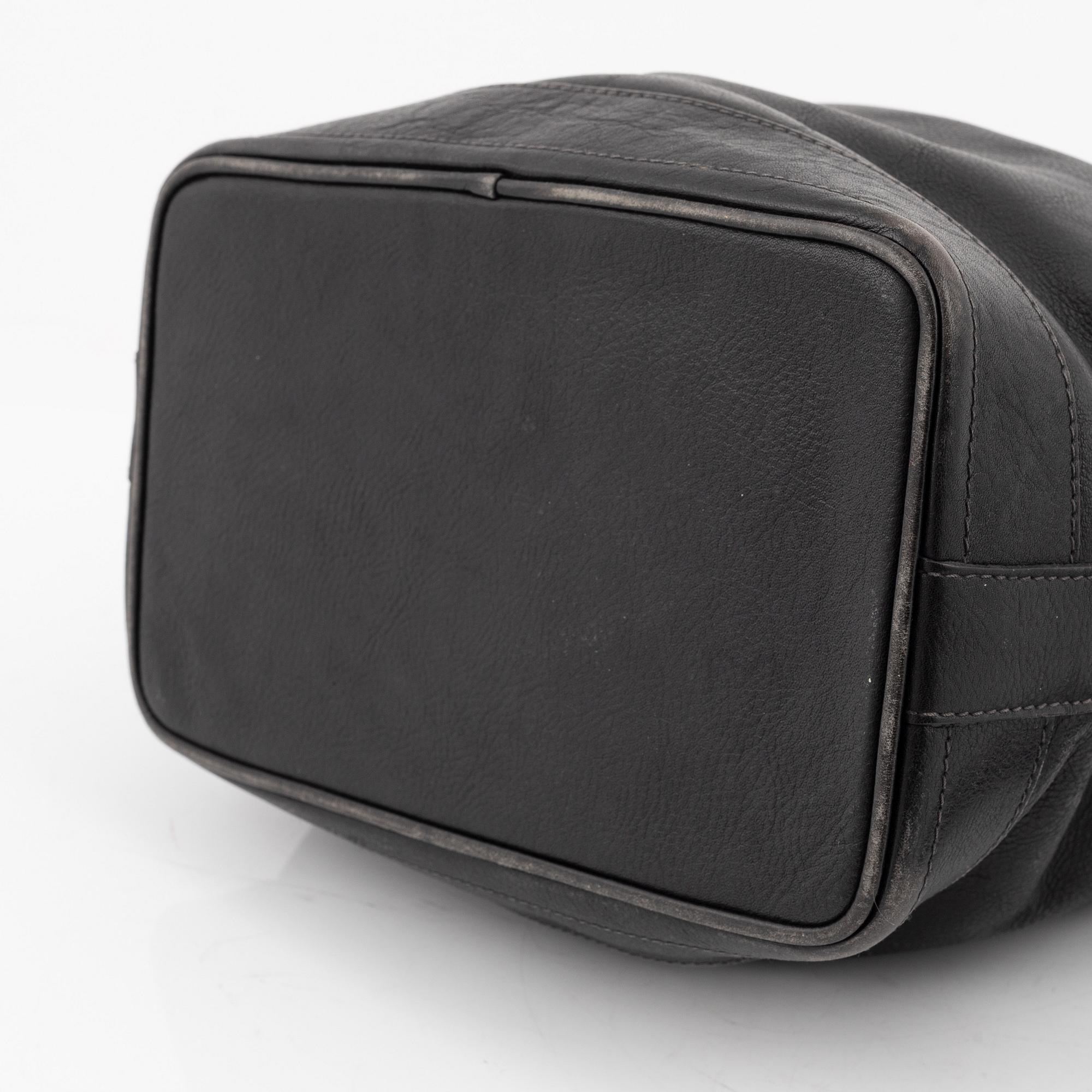 Kenzo, a black leather bucket bag.