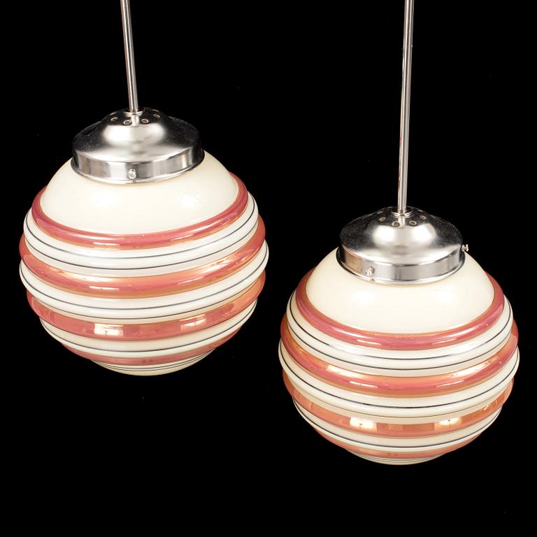 A pair och metal and and glass ceiling lights from the 1940s. Height ca 59 cm.