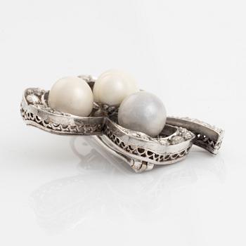 An antique shamrock pearl brooch.