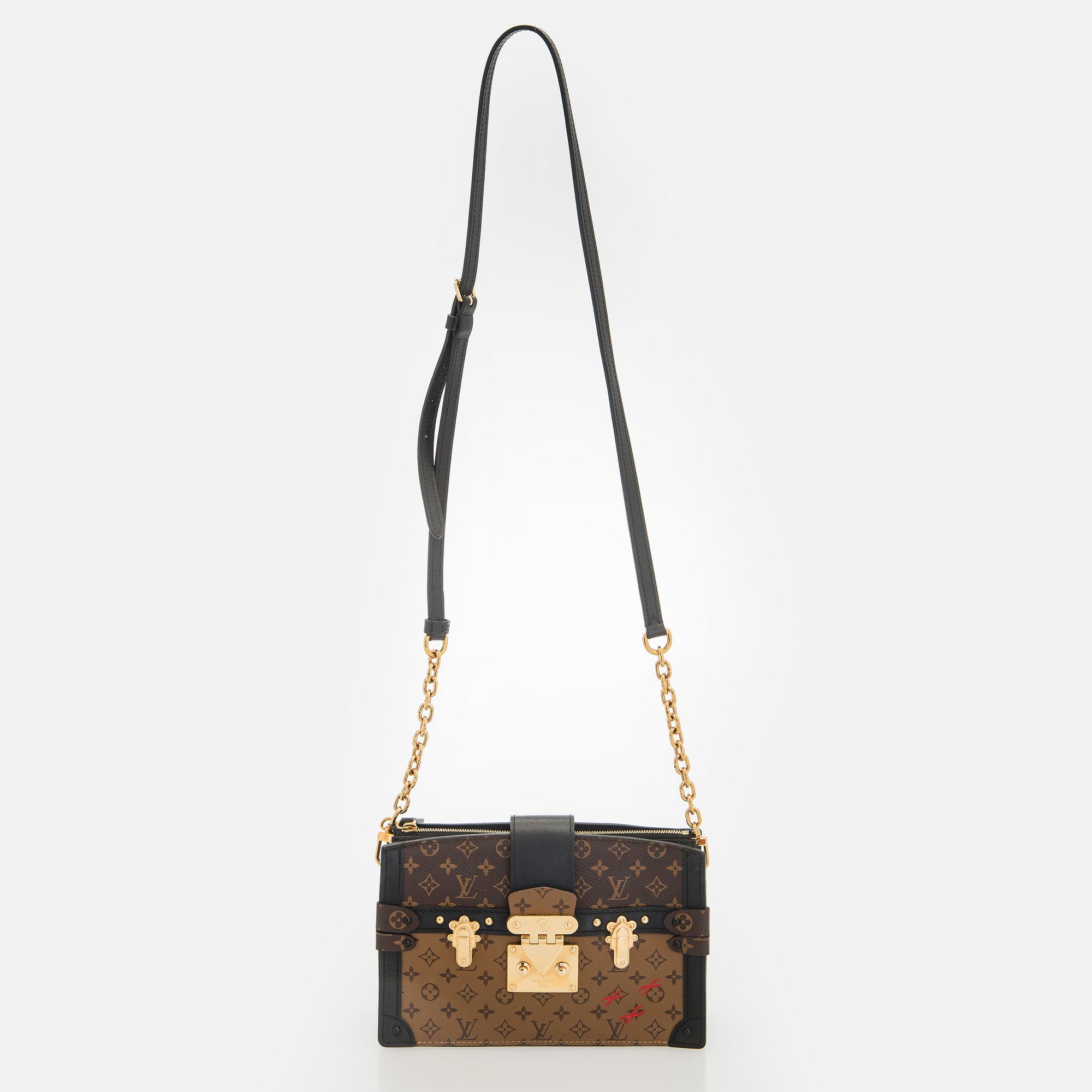 Louis Vuitton, a "Reverse Monogram Trunk Clutch" bag.