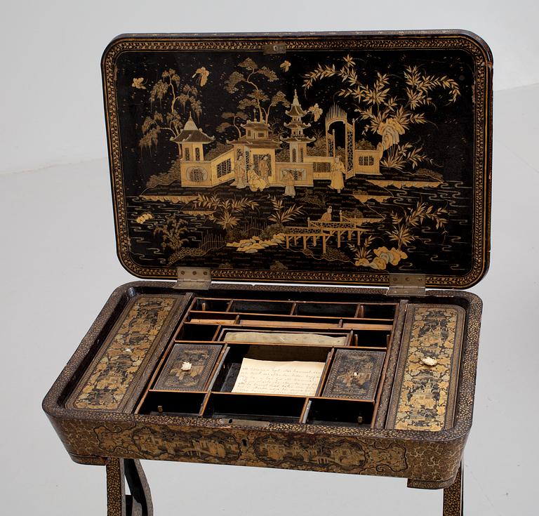 A gold and black lacquer sewing table, Qing dynasty, ca 1800.