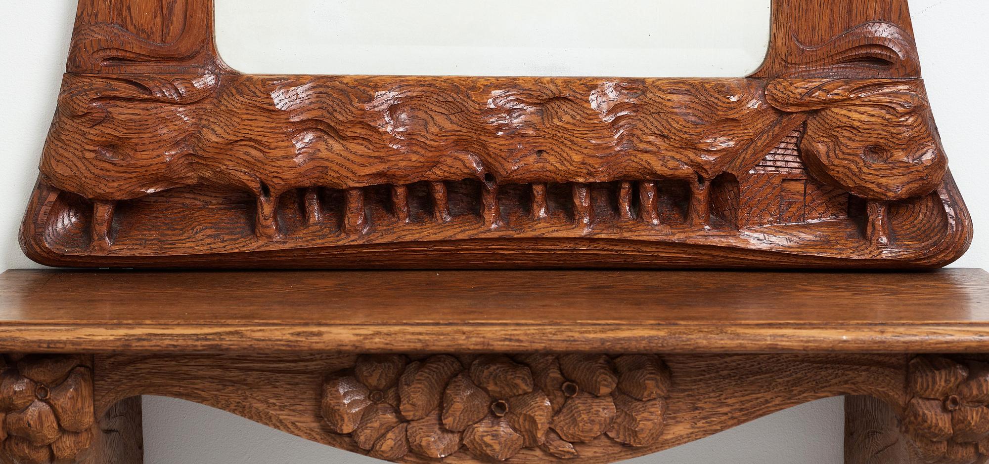 An Art Nouveau oak wall mirror with a console table.