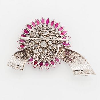 An 18K white gold brooch set with round brilliant-cut diamonds and navette-cut rubies.